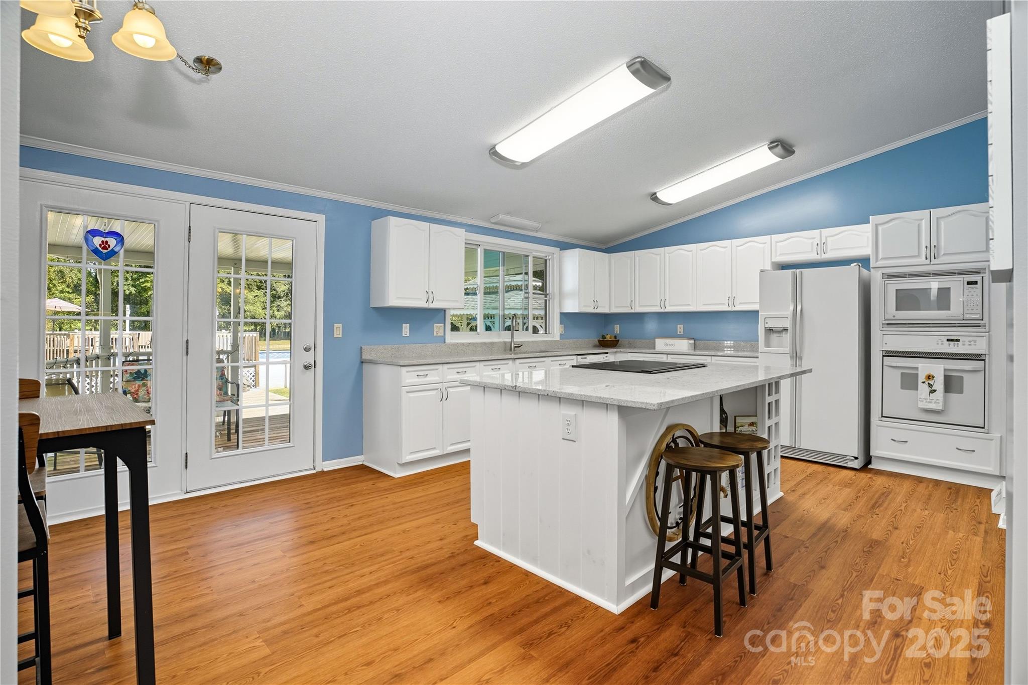 1660 Lentz Road China Grove, NC 28023 - Photo 12 of 44 a kitchen with stainless steel appliances granite countertop a refrigerator a stove top oven a sink dishwasher and white cabinets with wooden floor