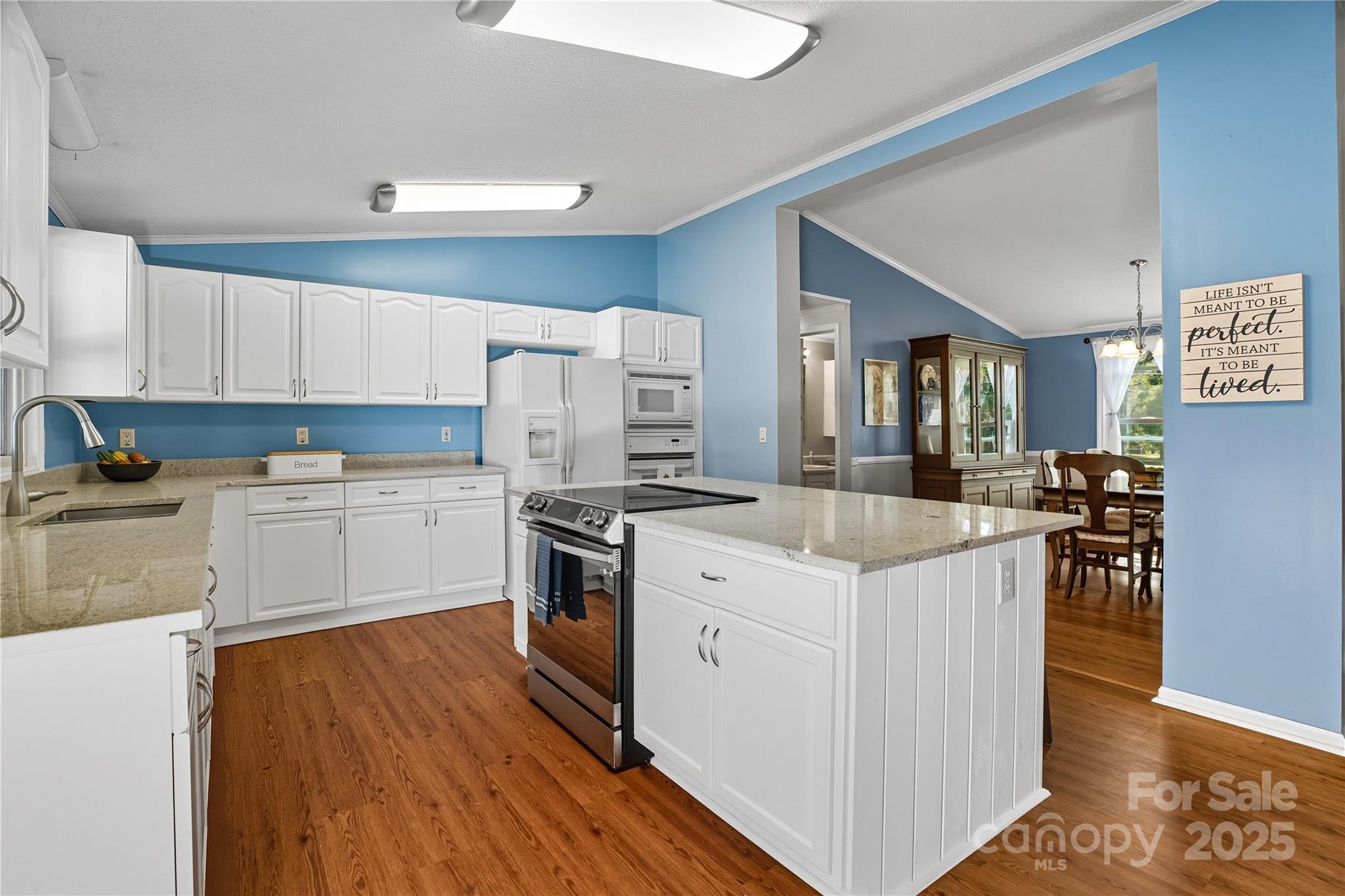 1660 Lentz Road China Grove, NC 28023 - Photo 15 of 44 a kitchen with granite countertop white cabinets and white appliances