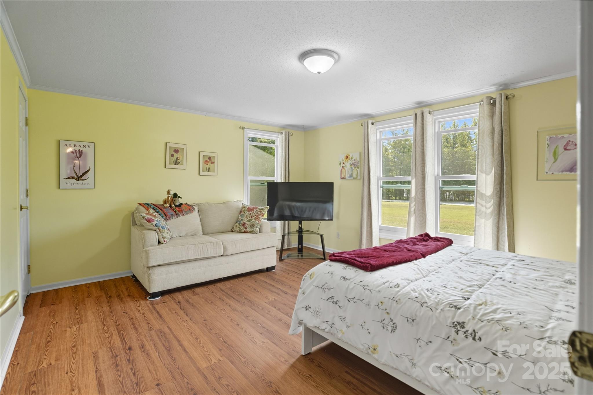 1660 Lentz Road China Grove, NC 28023 - Photo 21 of 44 a spacious bedroom with a bed and wooden floor