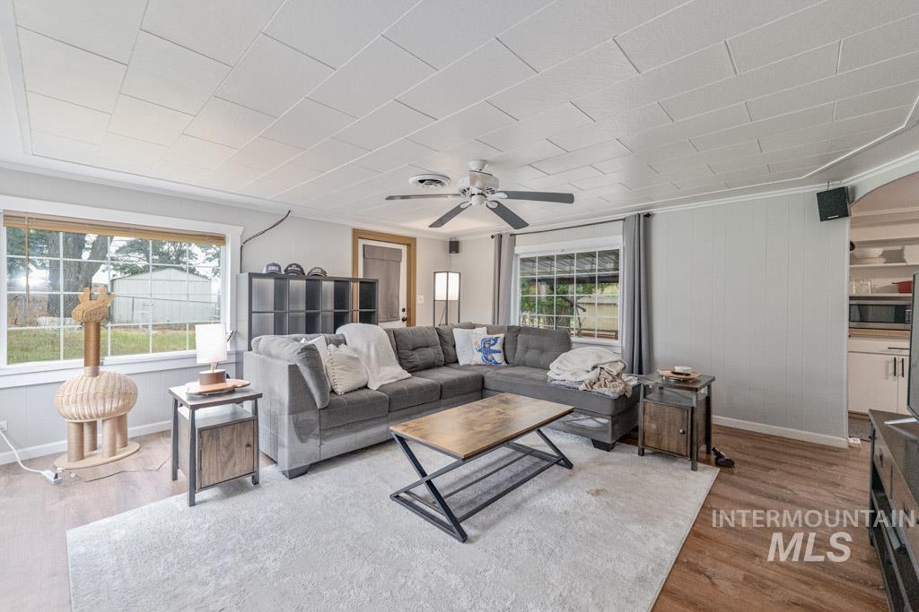 259 Highway 12 Pomeroy, WA 99347 - Photo 18 of 45 Living area featuring wood-finish flooring, a white paneled ceiling, and a ceiling fan