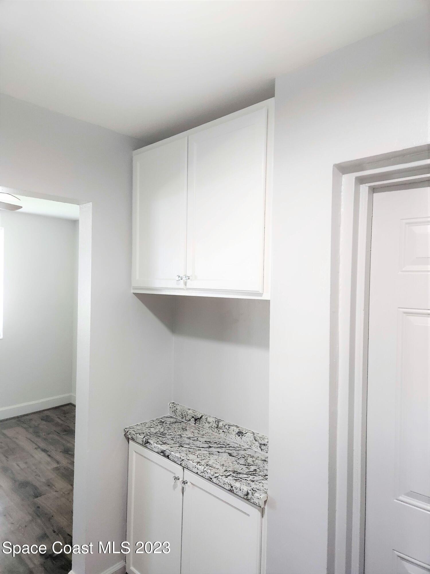 8401 North Atlantic Avenue, Unit K9 Cape Canaveral, FL 32920 - Photo 3 of 14 a kitchen with a sink and cabinets