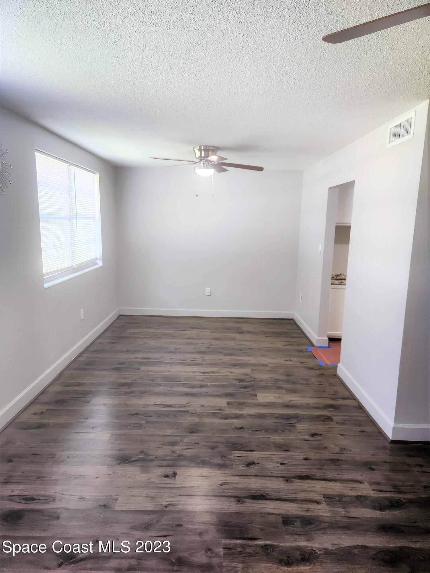 8401 North Atlantic Avenue, Unit K9 Cape Canaveral, FL 32920 - Photo 4 of 14 wooden floor in an empty room