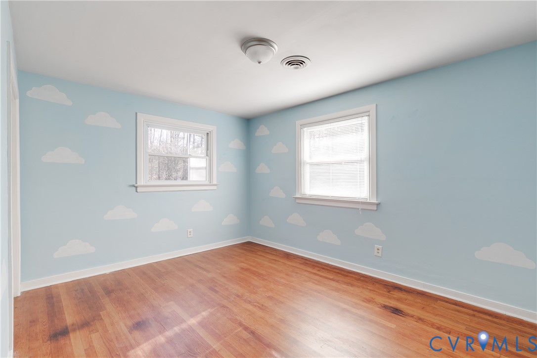 1180 Berryhill Road Henrico, VA 23231 - Photo 12 of 23 a view of empty room with wooden floor and fan