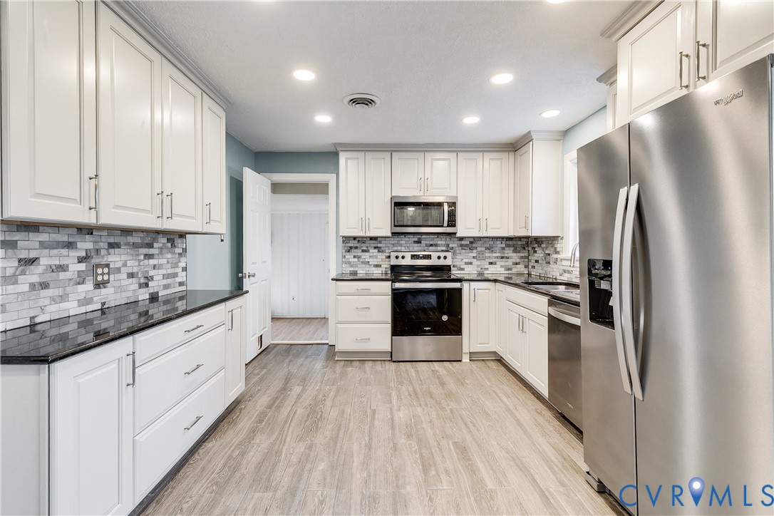 1180 Berryhill Road Henrico, VA 23231 - Photo 6 of 23 a kitchen with stainless steel appliances a refrigerator sink and microwave