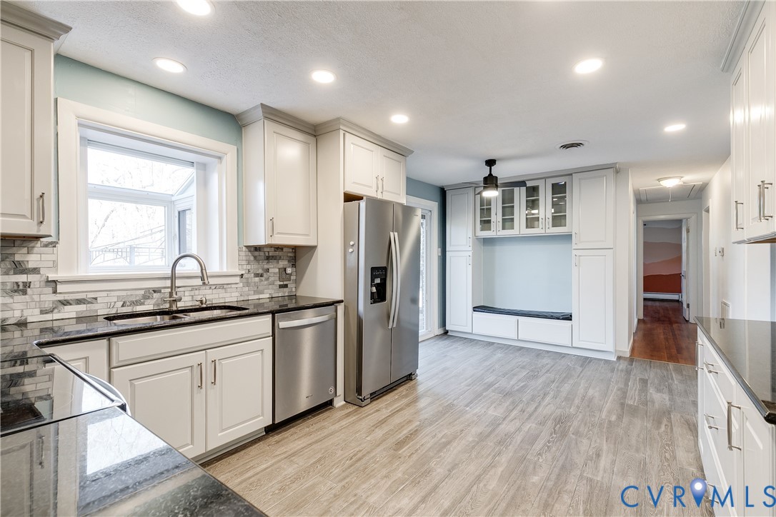 1180 Berryhill Road Henrico, VA 23231 - Photo 8 of 23 a kitchen with stainless steel appliances granite countertop a refrigerator a sink dishwasher and a stove with wooden floor