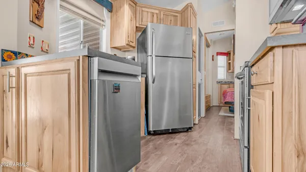 a kitchen with stainless steel appliances granite countertop a stove a sink dishwasher and cabinets with wooden floor