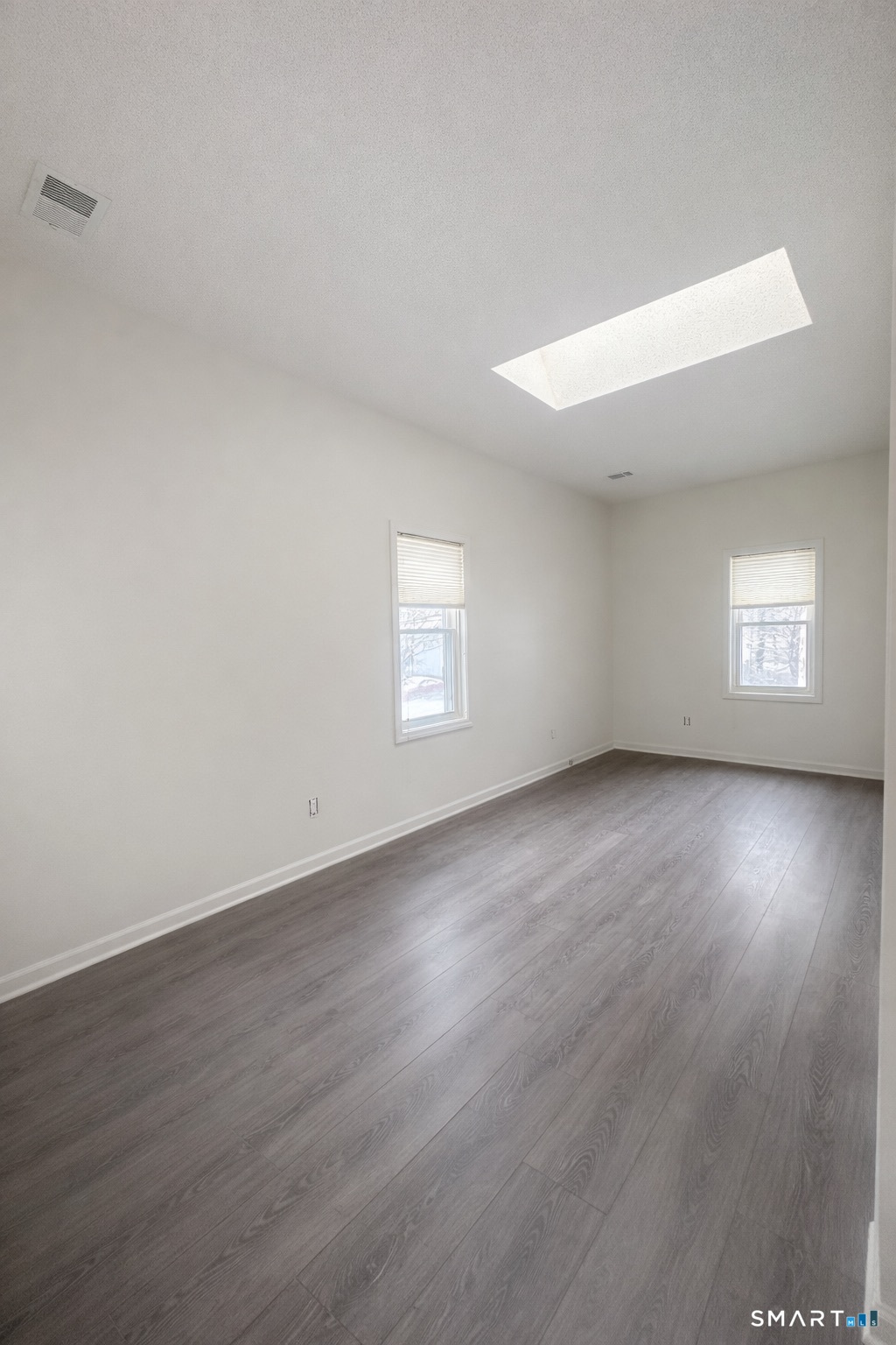 44 Hard Street, Unit 4 New Haven, CT 06515 - Photo 12 of 14 an empty room with wooden floor and windows