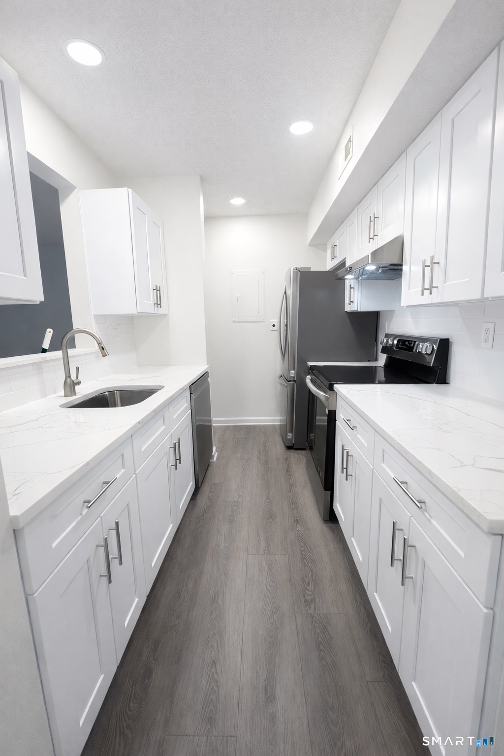 44 Hard Street, Unit 4 New Haven, CT 06515 - Photo 4 of 14 a large white kitchen with stainless steel appliances sink a stove and white cabinets