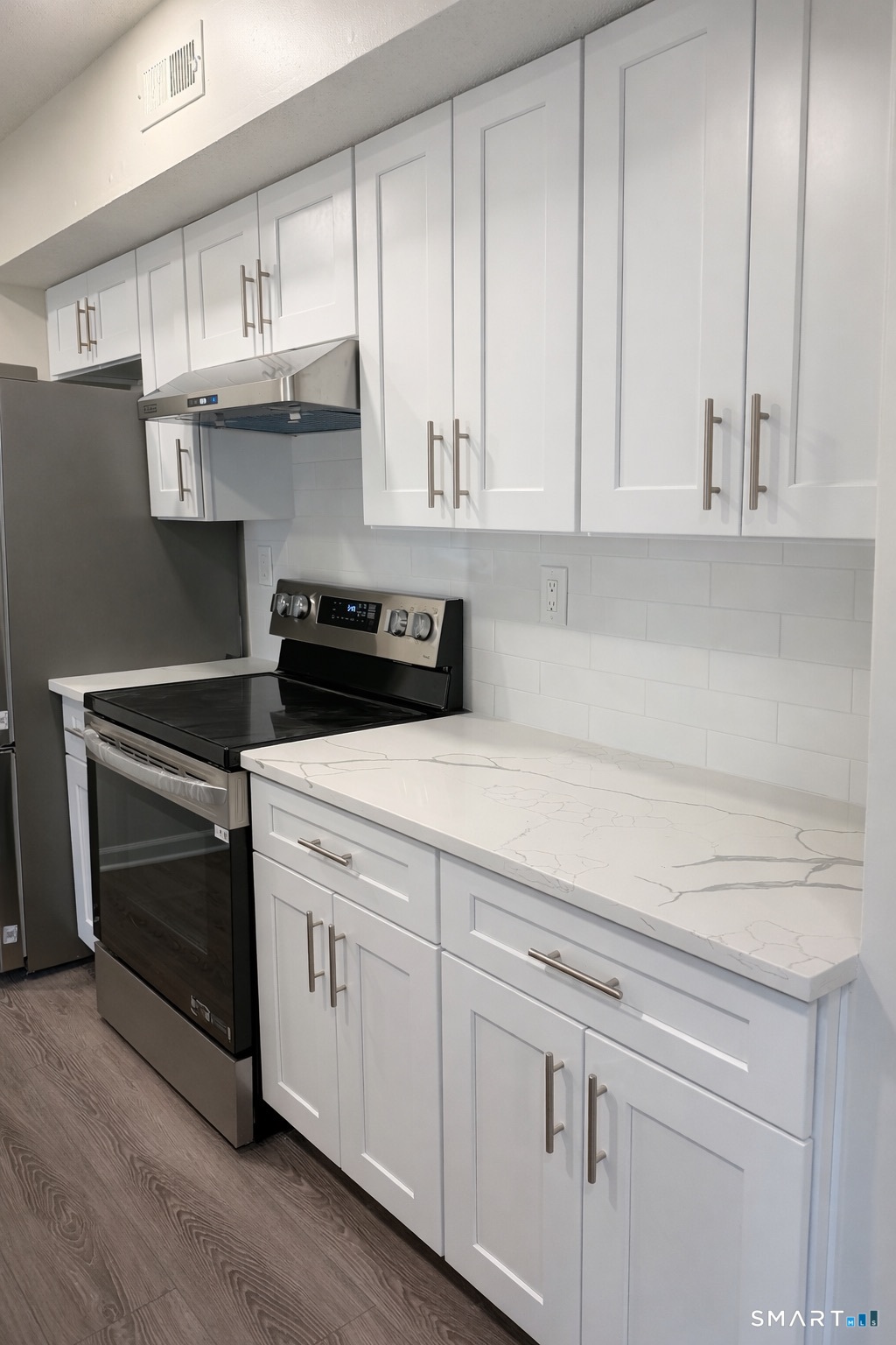 44 Hard Street, Unit 4 New Haven, CT 06515 - Photo 6 of 14 a kitchen with stainless steel appliances granite countertop white cabinets and a granite counter tops