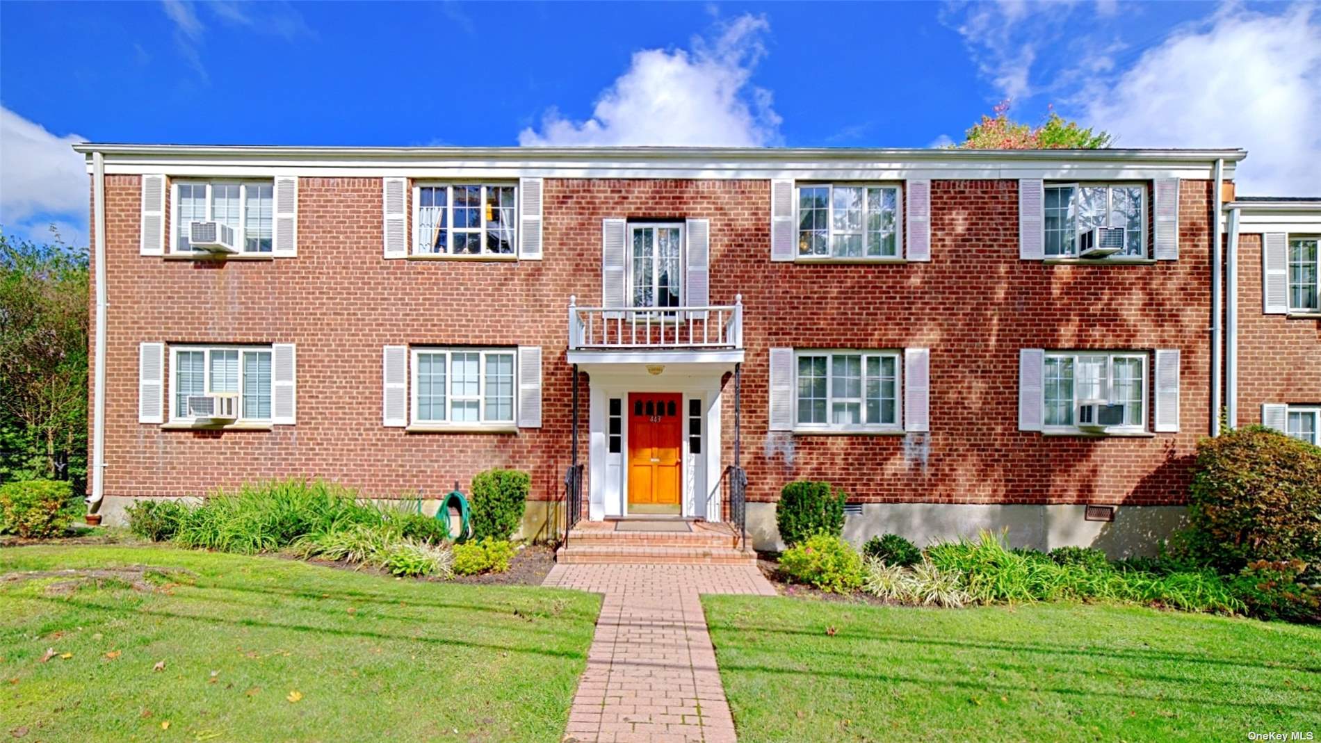 443 Main Street, Unit 2B Huntington, NY 11743 - Photo 1 of 1 a front view of a brick house with a yard