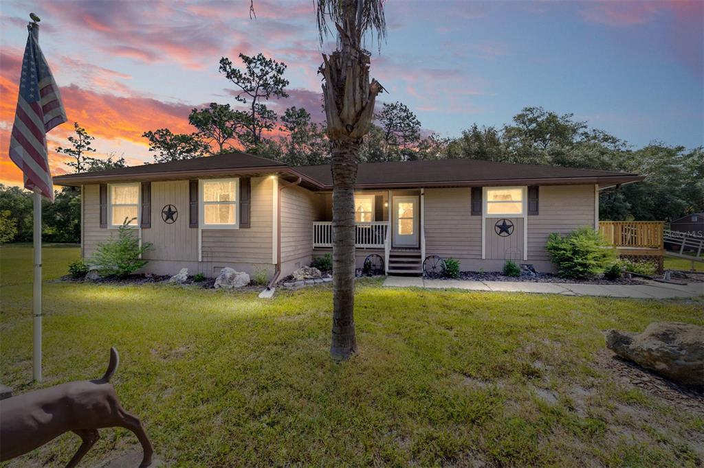 15755 Southwest 90th Avenue Dunnellon, FL 34432 - Photo 5 of 55 a front view of a house with garden