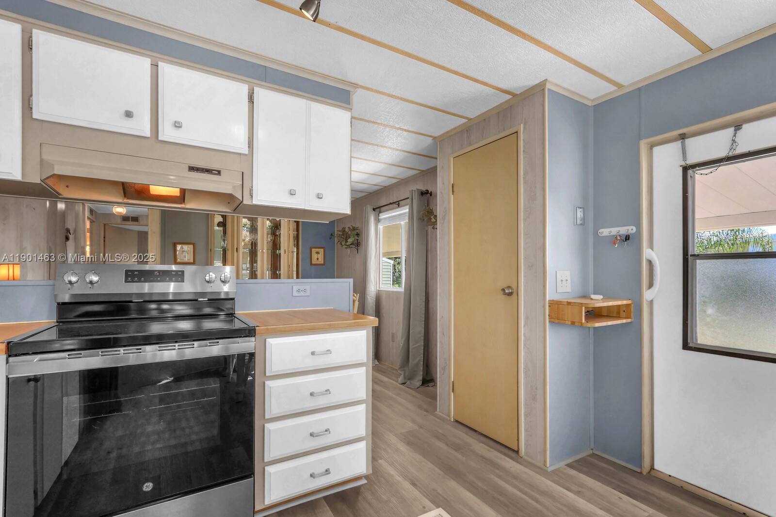 8191 Southeast Homestead Avenue, Unit 8191 Hobe Sound, FL 33455 - Photo 17 of 38 a kitchen with stainless steel appliances granite countertop a stove and a refrigerator