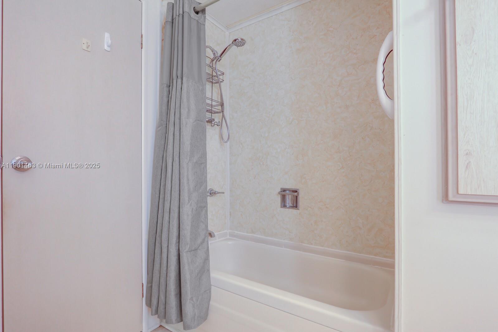 8191 Southeast Homestead Avenue, Unit 8191 Hobe Sound, FL 33455 - Photo 29 of 38 a bathroom with a bathtub