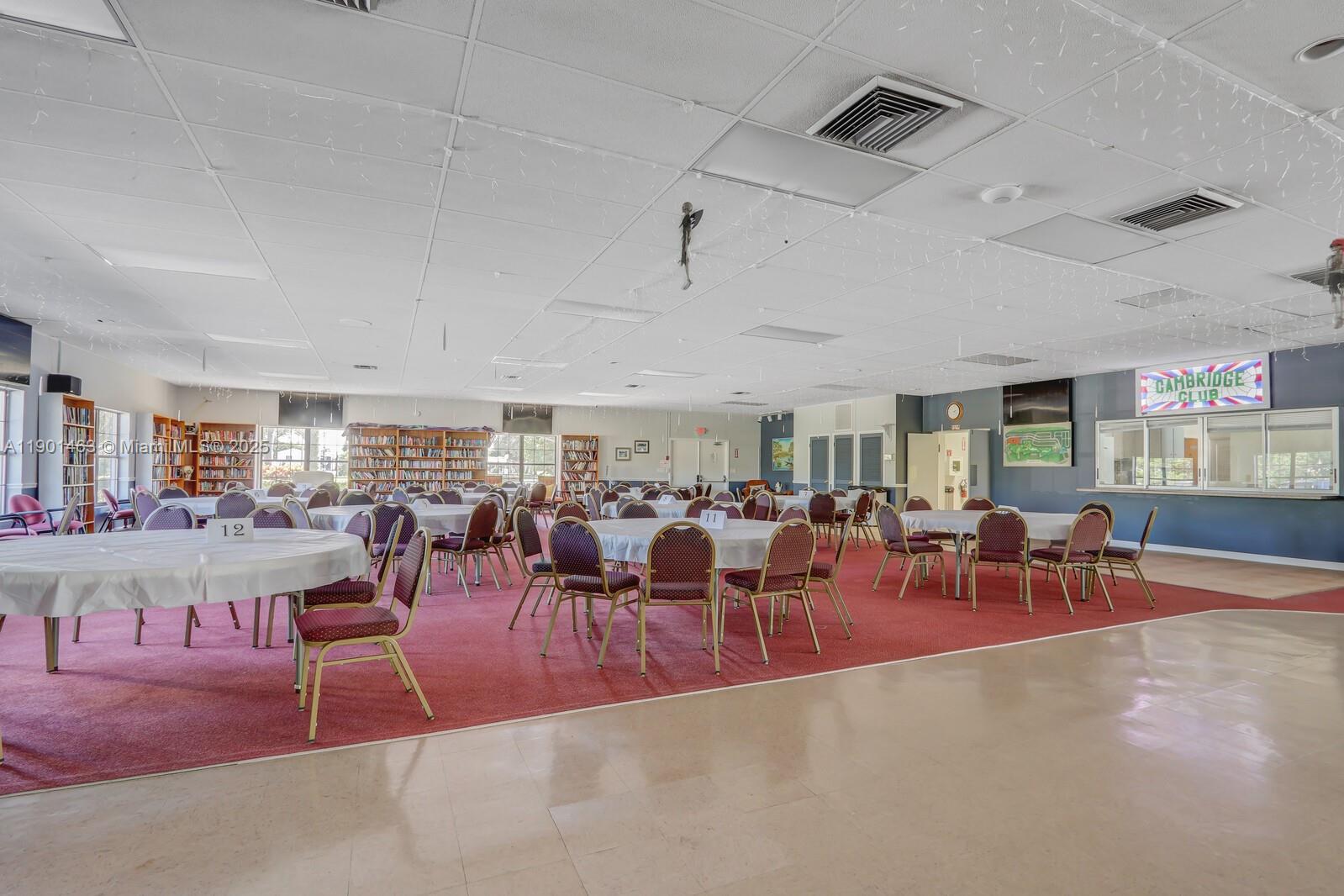 8191 Southeast Homestead Avenue, Unit 8191 Hobe Sound, FL 33455 - Photo 36 of 38 a living room with lots of furniture and a large mirror