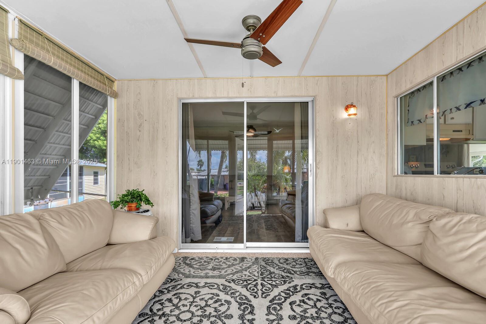 8191 Southeast Homestead Avenue, Unit 8191 Hobe Sound, FL 33455 - Photo 4 of 38 a living room with furniture and a window