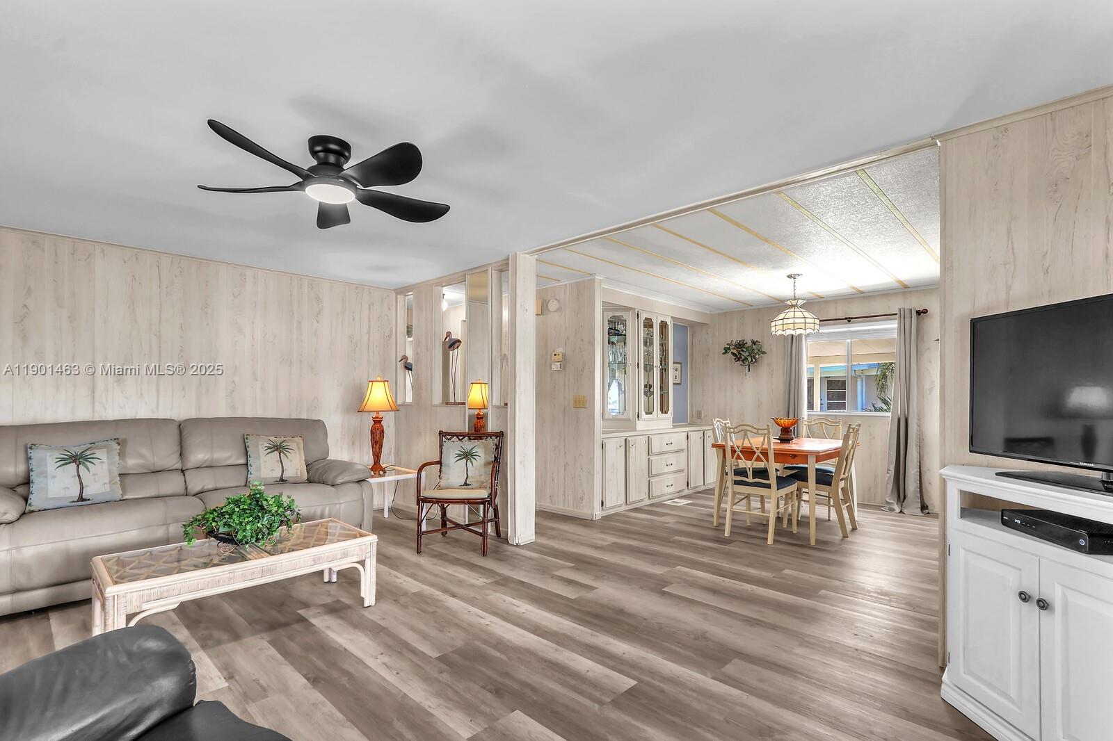 8191 Southeast Homestead Avenue, Unit 8191 Hobe Sound, FL 33455 - Photo 7 of 38 a view of a dining room with furniture window and wooden floor