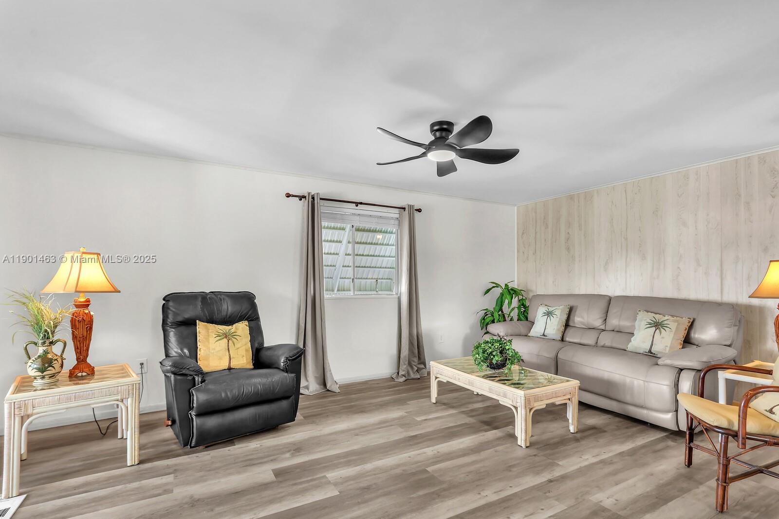 8191 Southeast Homestead Avenue, Unit 8191 Hobe Sound, FL 33455 - Photo 10 of 38 a living room with furniture and wooden floor