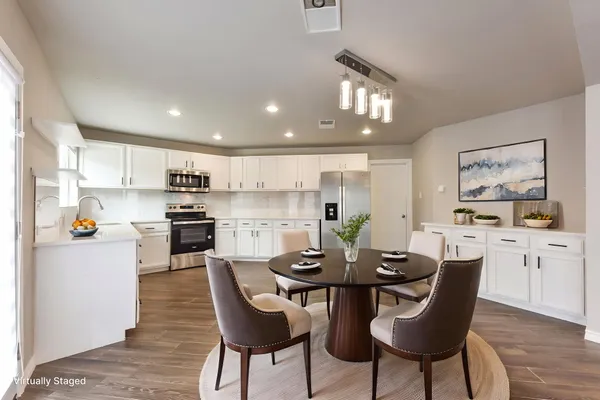a view of a dining room with furniture and wooden floor