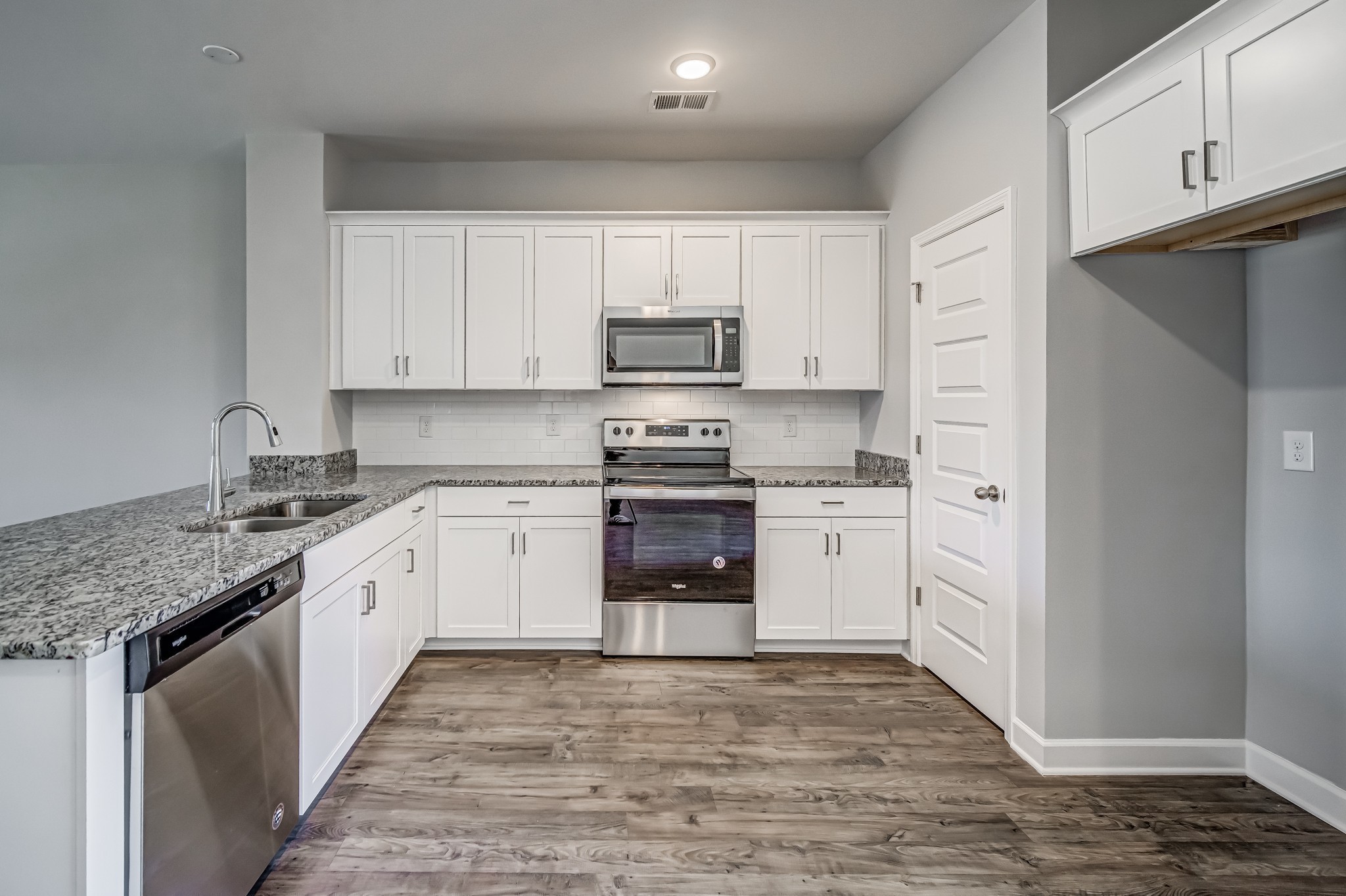 1742 Fenway Loop Antioch, TN 37013 - Photo 12 of 15 a kitchen with granite countertop white cabinets and stainless steel appliances