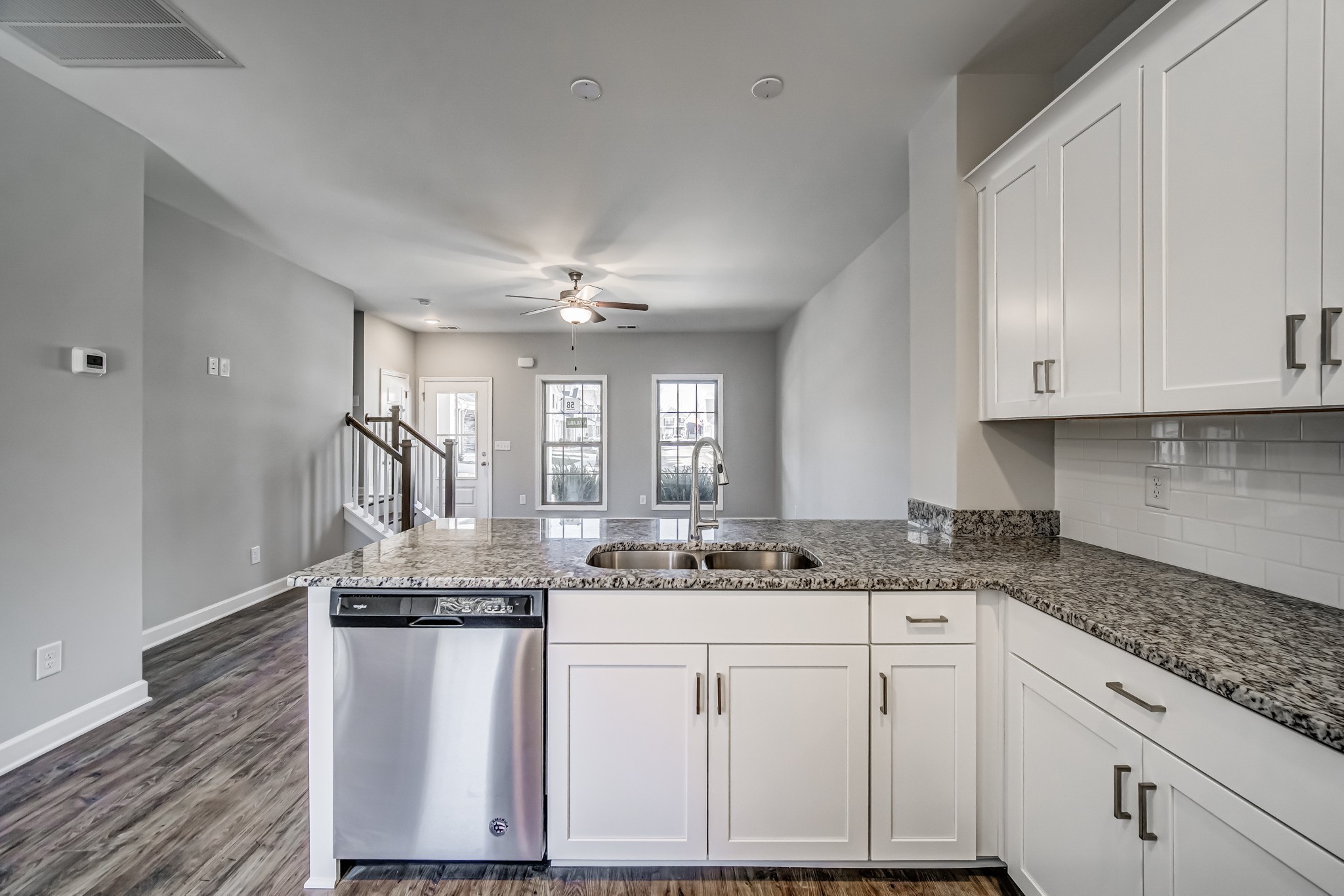 1742 Fenway Loop Antioch, TN 37013 - Photo 14 of 15 a kitchen with kitchen island granite countertop a sink cabinets and wooden floor