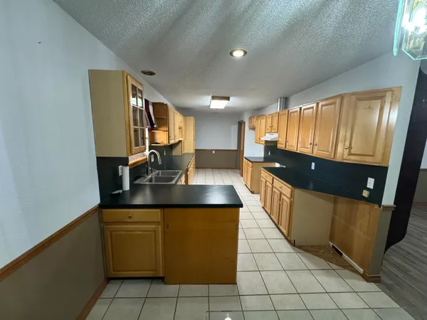 a kitchen with stainless steel appliances a sink stove and cabinets