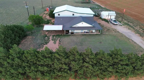 an aerial view of a house with outdoor space swimming pool