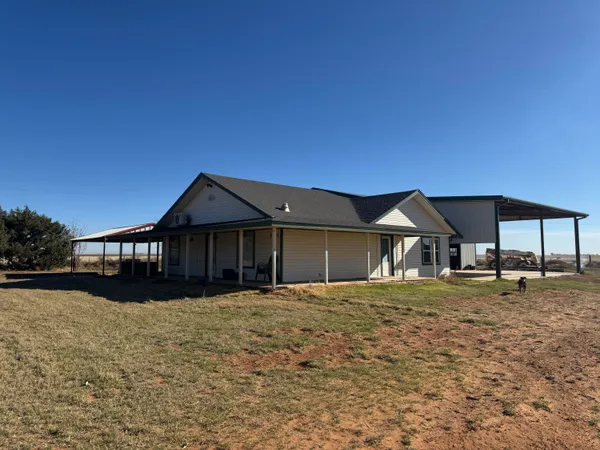 a big house with a yard and plants