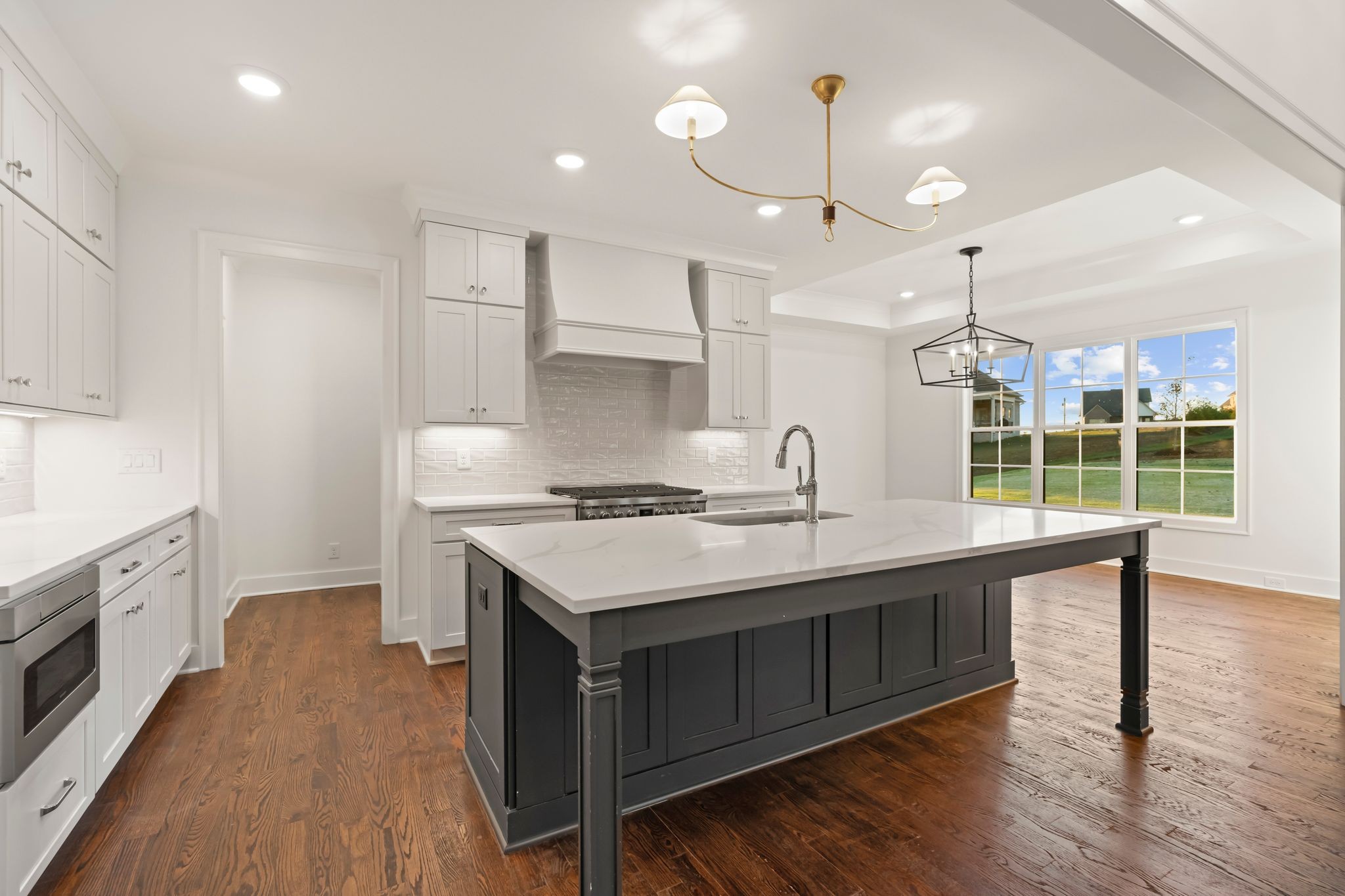 307 Oak Street Lebanon, TN 37087 - Photo 12 of 46 a kitchen with granite countertop a sink appliances and wooden floor