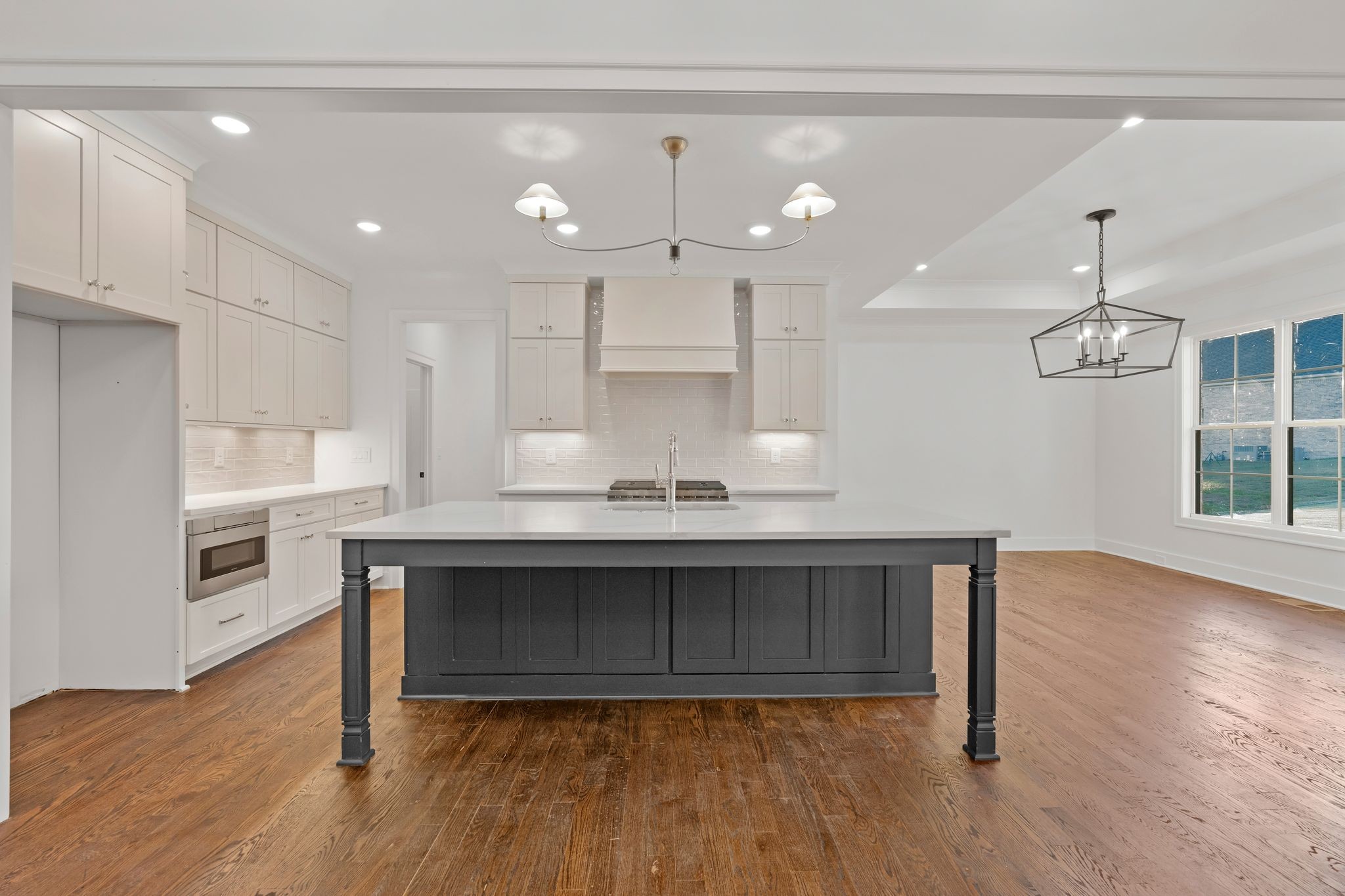 307 Oak Street Lebanon, TN 37087 - Photo 14 of 46 a large kitchen with stainless steel appliances granite countertop a wooden floor and a view of living room