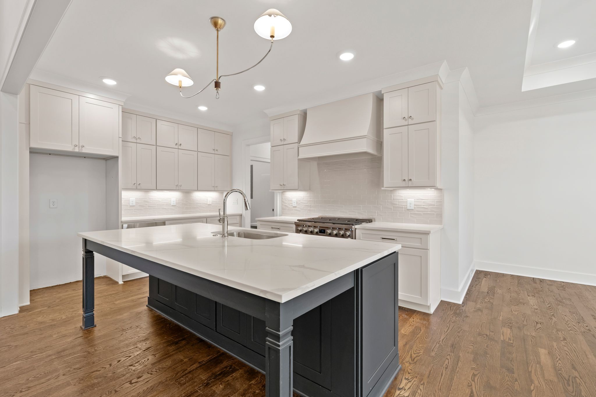 307 Oak Street Lebanon, TN 37087 - Photo 16 of 46 a kitchen that has a sink a stove and a wooden floor