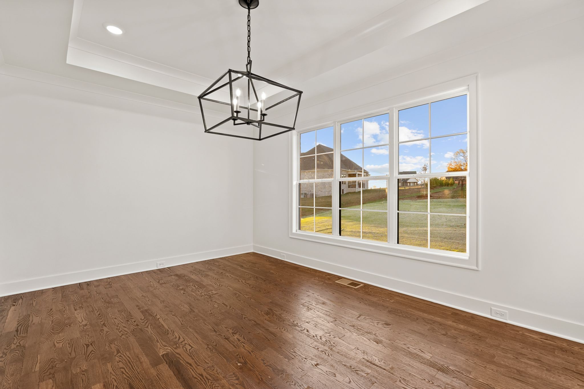 307 Oak Street Lebanon, TN 37087 - Photo 20 of 46 a view of an empty room with wooden floor and chandelier