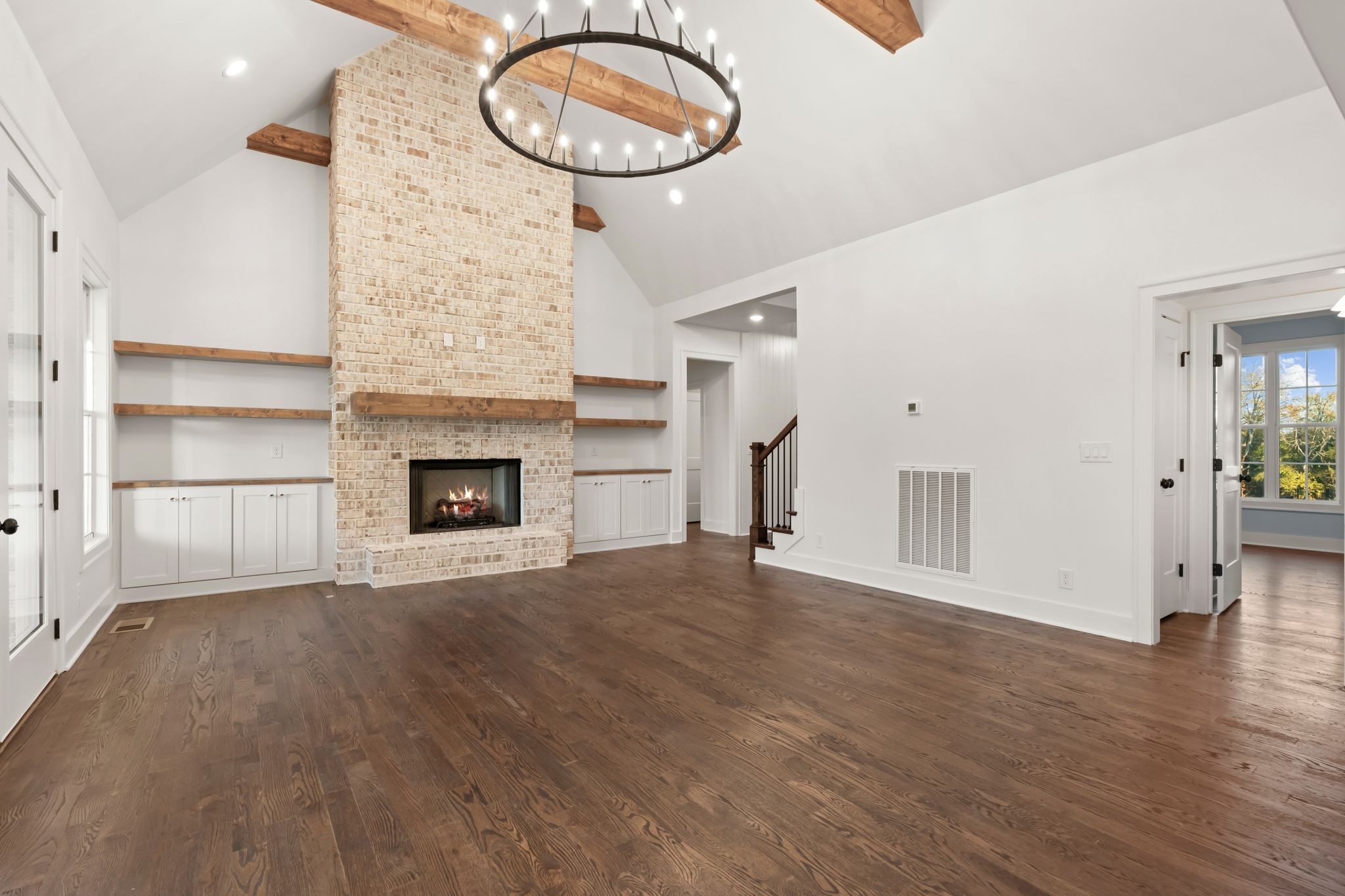 307 Oak Street Lebanon, TN 37087 - Photo 9 of 46 a view of an empty room with a fireplace and wooden floor