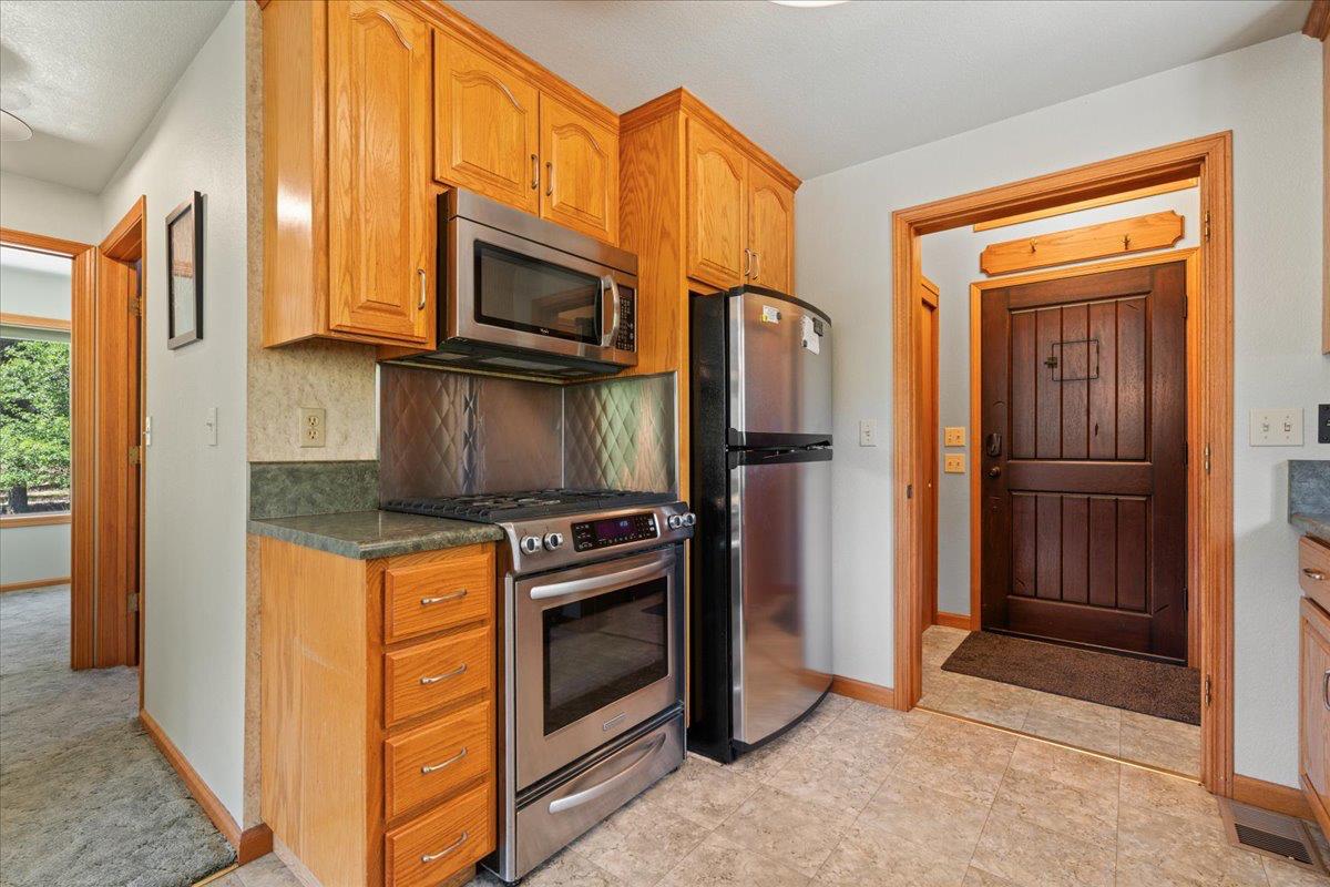 200 Craycroft Ridge Road Downieville, CA 95936 - Photo 3 of 34 a kitchen with stainless steel appliances granite countertop a refrigerator a stove and a sink