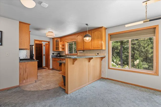 a view of kitchen with furniture and refrigerator