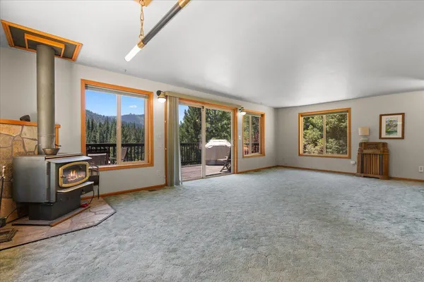 a living room with furniture and large windows