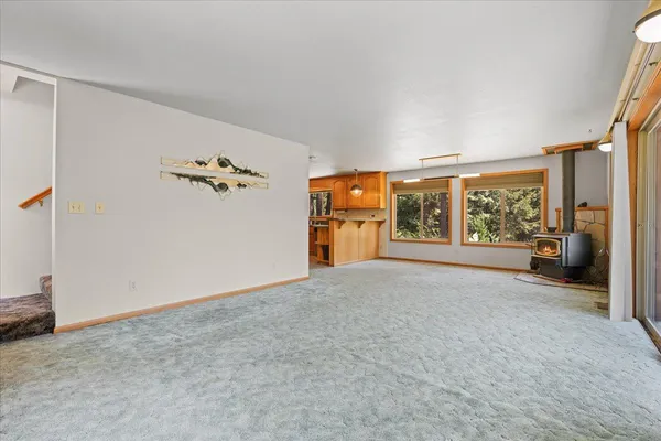 a view of an empty room with a window and storage