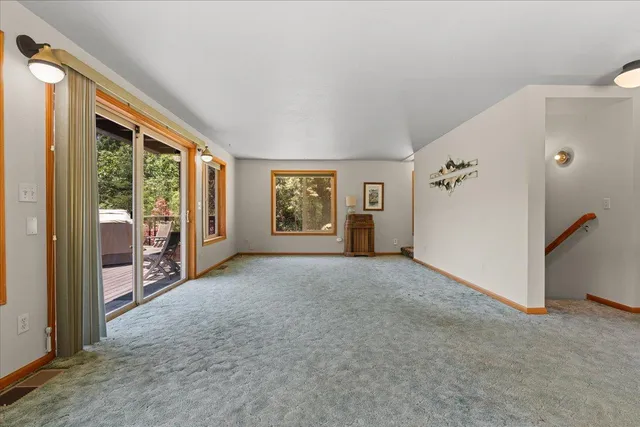 a view of a big room with windows and closet