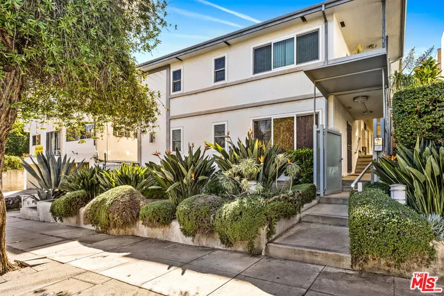 a view of a chairs and table in the backyard