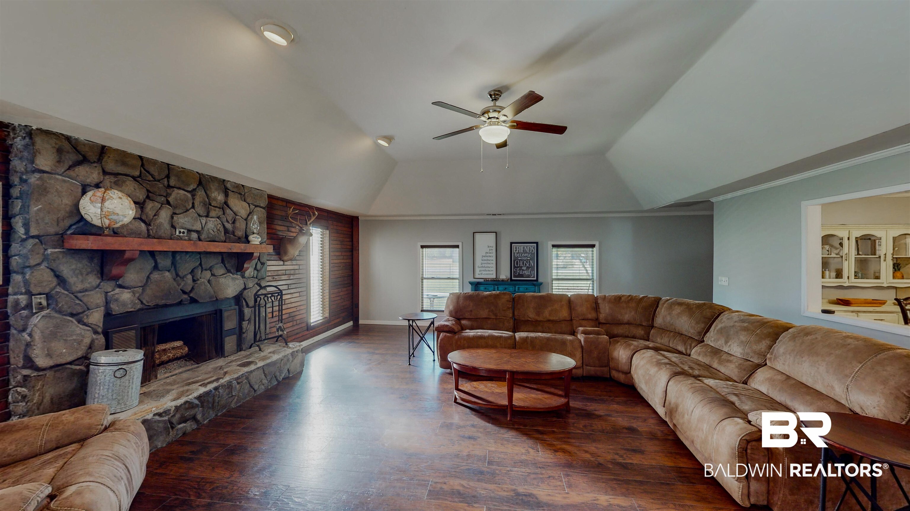 19365 Keller Road Foley, AL 36535 - Photo 16 of 41 Living room with ceiling fan, a raised ceiling, dark hardwood / wood-style flooring, built in features, and a fireplace