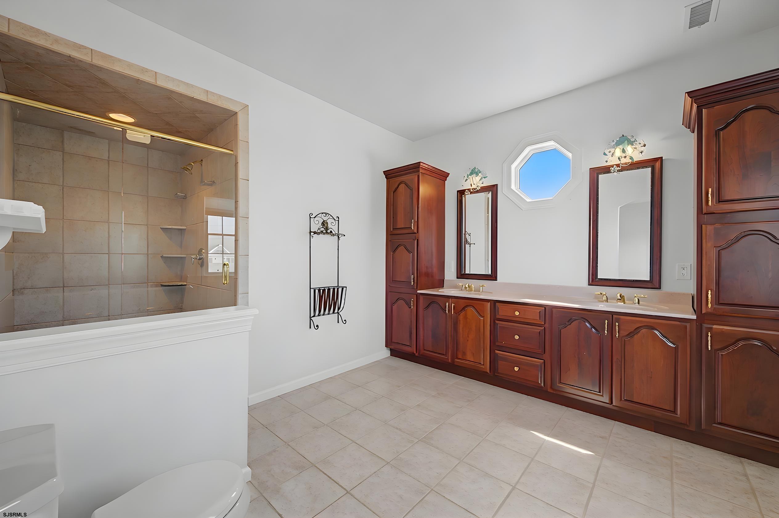 212 17th Street South Brigantine, NJ 08203 - Photo 23 of 37 a spacious bathroom with a granite countertop sink mirror and bathtub