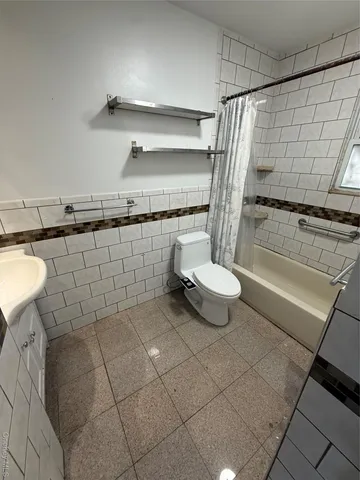 a bathroom with a shower and a sink
