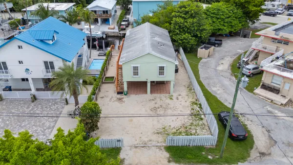 an aerial view of a house with a yard