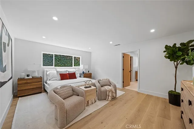 a bathroom with a double vanity sink toilet mirror and bathtub