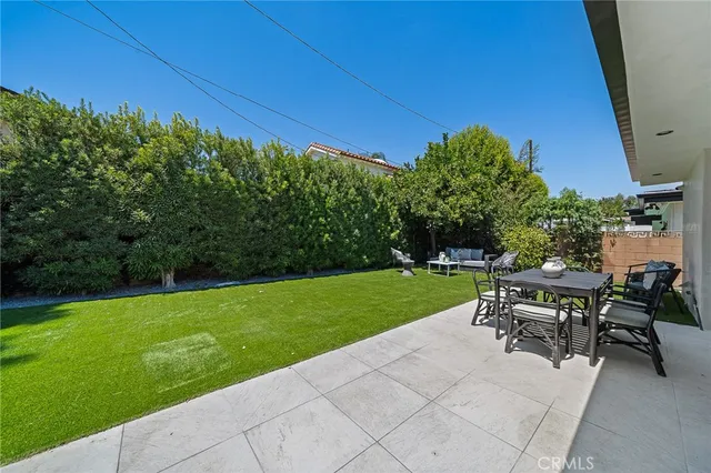 a view of a chairs and table in patio