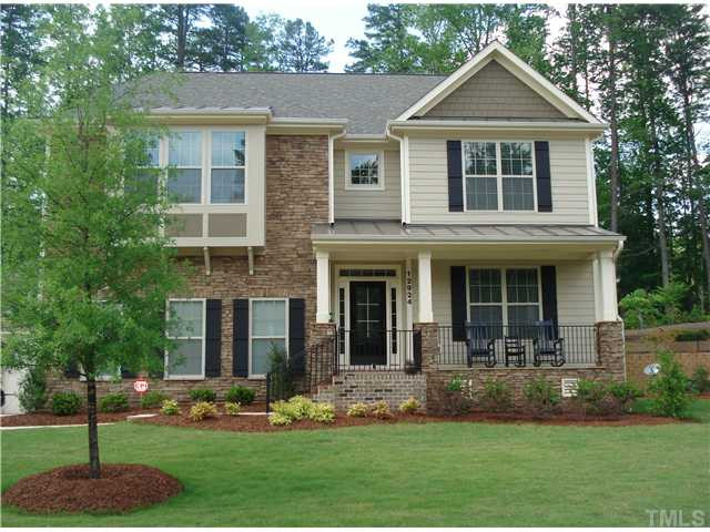 Beautiful stone, brick and shake facade, also has metal roof over porch and bay window. All virtually maintenance free! Rocking chair front porch with wrought iron railings. Great place to enjoy a spring evening! Facade/Exterior Front