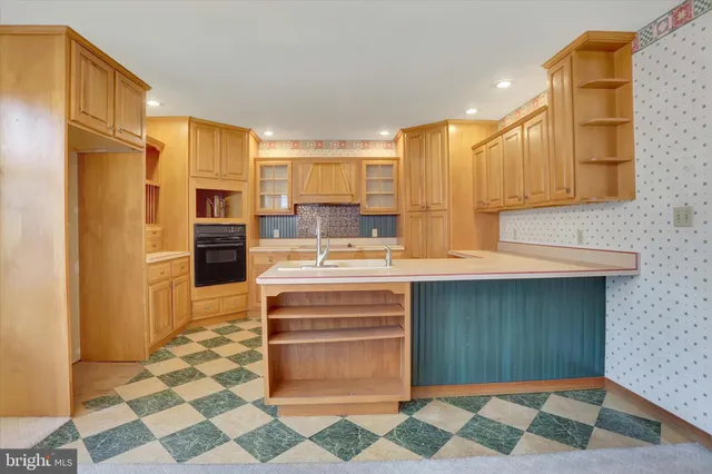a kitchen with a sink stove and cabinets