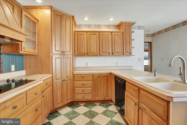 a kitchen with granite countertop stainless steel appliances and cabinets