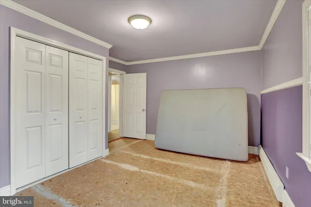 an empty room with windows and closet