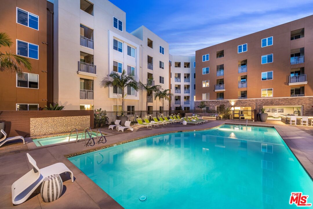 7290 Edinger Avenue, Unit 4038 Huntington Beach, CA 92647 - Photo 21 of 24 a swimming pool with outdoor seating and yard