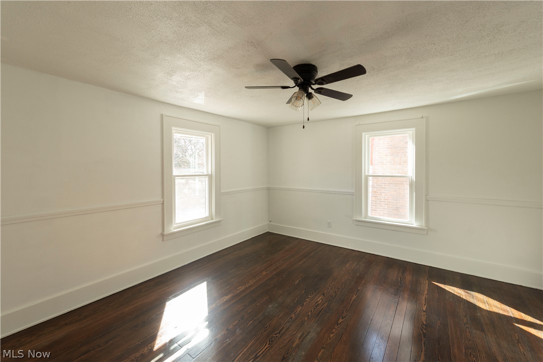 1022 North Howard Street Akron, OH 44310 - Photo 16 of 38 Bedroom 1 with plenty of natural light, ceiling fan, and refinished dark hardwood flooring